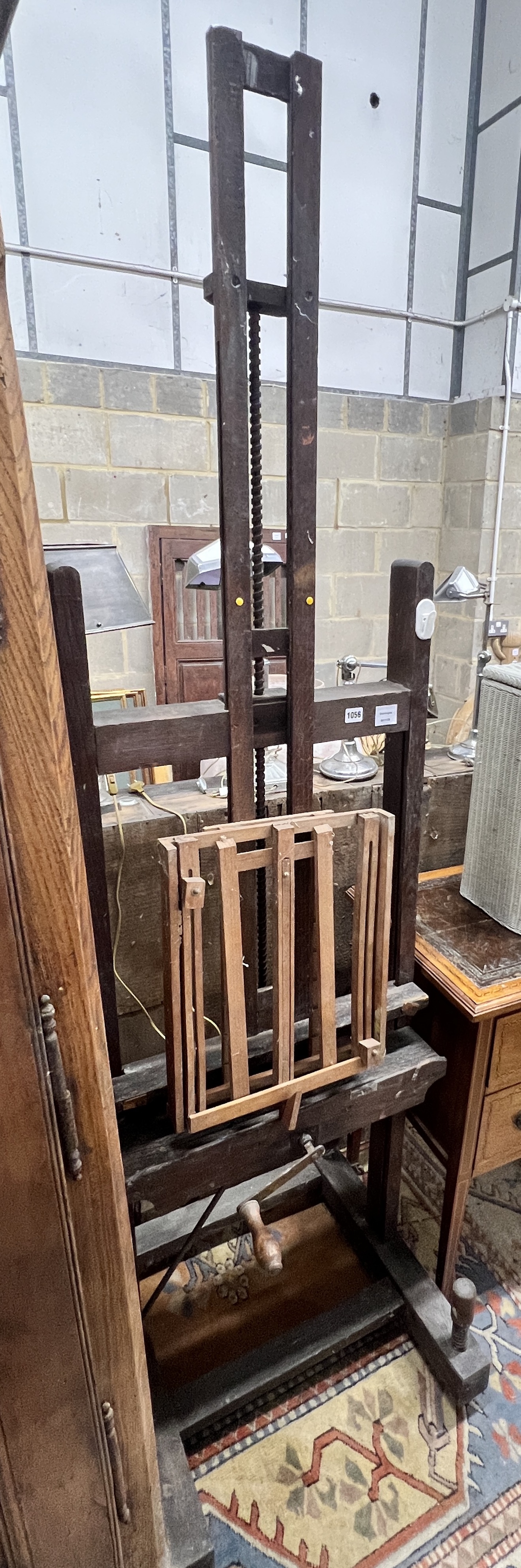 A late Victorian oak artist's studio easel, together with a later travelling easel